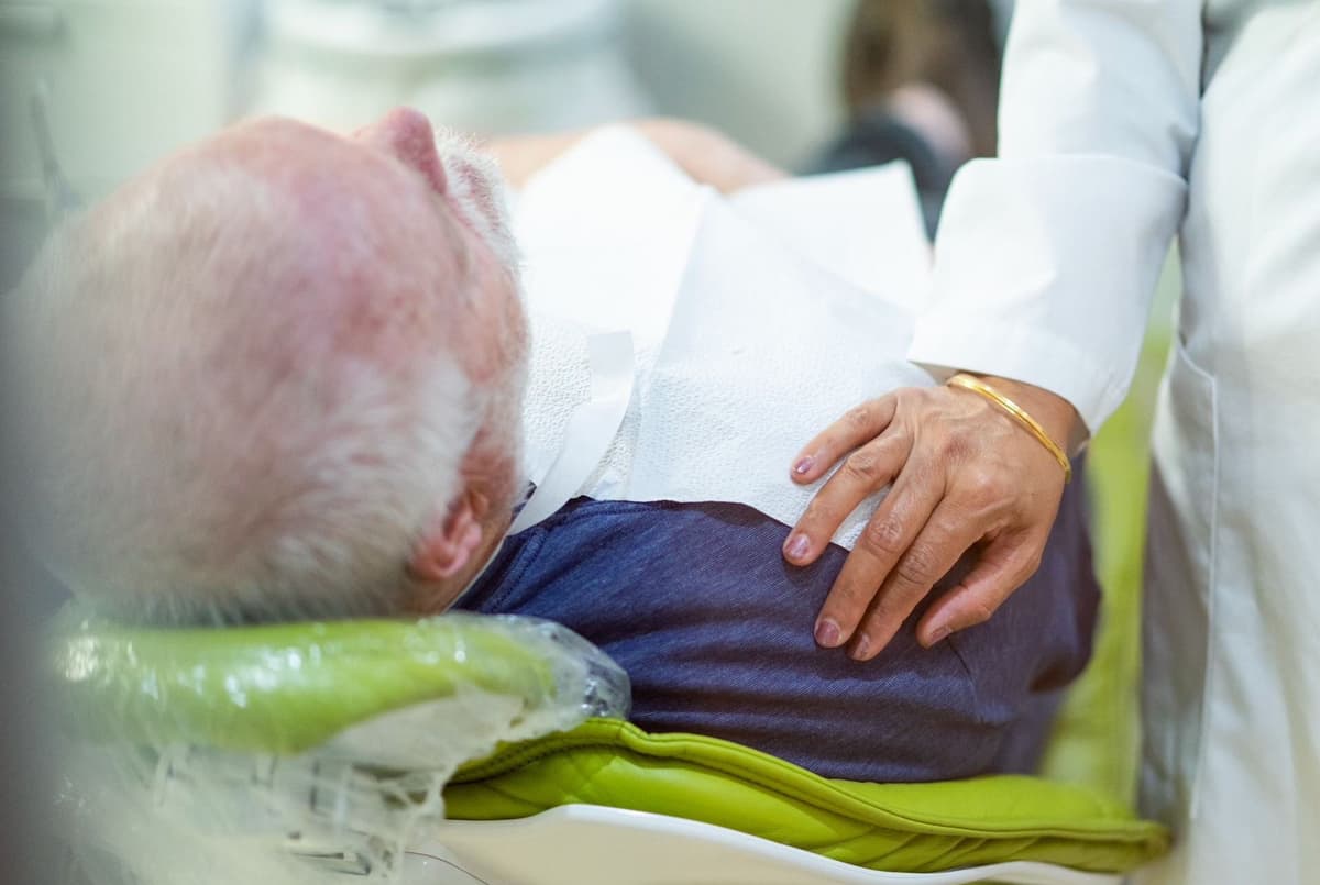 Dr. Talwar providing compassionate patient care at Esthetique Dentistry